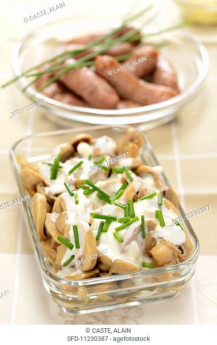 Mushrooms with chive sauce and mini sausages