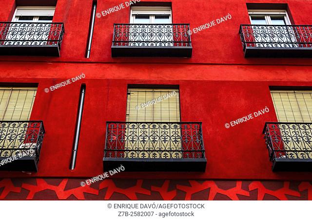 A red front of a building in a central street of Madrid city, Spain