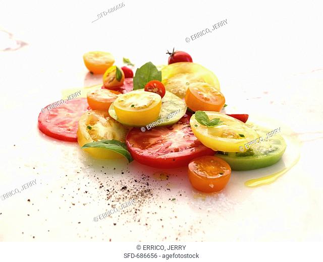 Assorted Sliced Tomatoes with Olive Oil, Ground Pepper and Herbs