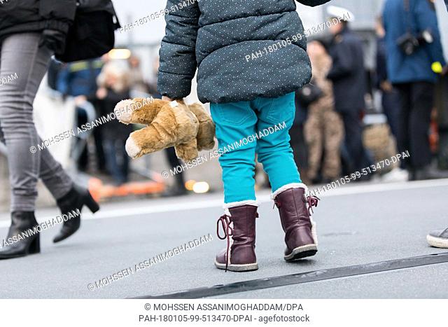 A small girl holding a teddy bear stands on the navy ship ""Sachsen"" at the naval base in Wilhelmshaven, Germany, 05 January 20187