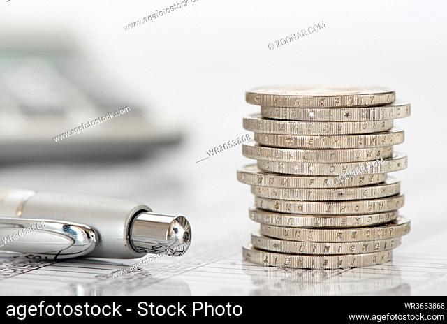 finance with stack of euro coins and calculator