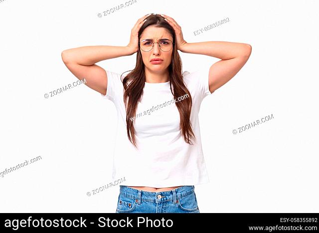 Waist-up portrait of troubled female student have big problem, grab head frowning and grimacing facing complex situation, dont know what do