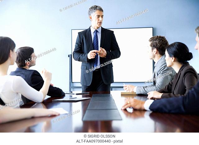 Executive making presentation at business meeting