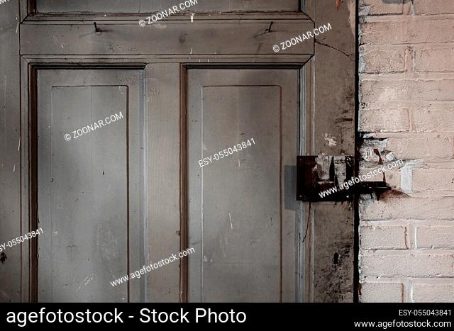 Old dirty wooden door industrial building dirty, close-up background texture darkness