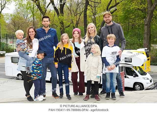 11 April 2019, Berlin: The two families Durchholz (l) and the Braavig family will present the film ""Zwei Familien auf Weltreise"" in front of the Filmtheater...