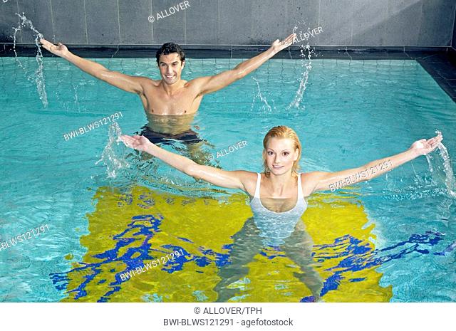 couple doing aquaerobic in pool