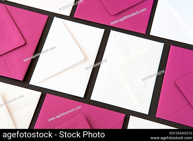 Composition with white and purple envelopes on the table. Different colored envelopes on the table