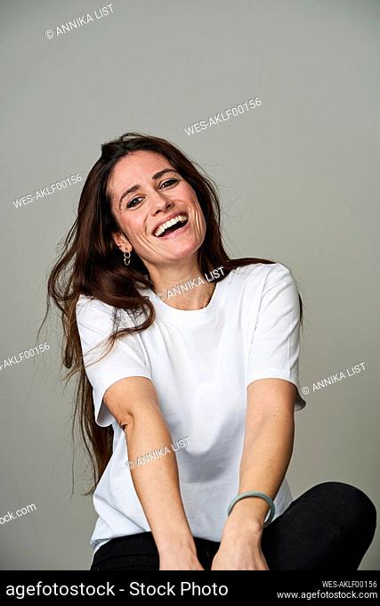 Cheerful woman against gray background