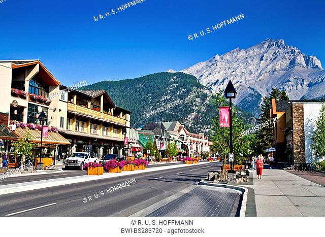 view through the main street in front of a picturesque mountain range with the Cascade Mountain, Canada, Alberta, Banff National Park, Banff