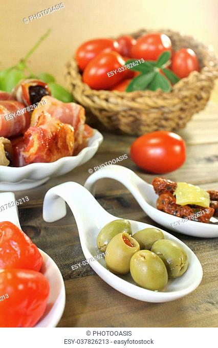 Tapas stuffed with prunes, figs and apricots on wooden plate