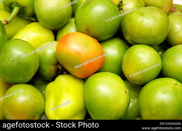 Green tomatoes at the market stall