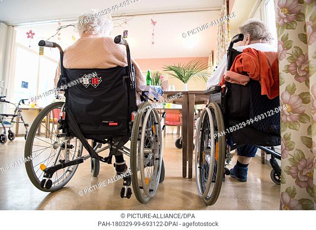 29 March 2018, Germany, Velten: Two residents of the Senior Centre Saint Elisabeth sit in wheelchairs. Photo: Christophe Gateau/dpa