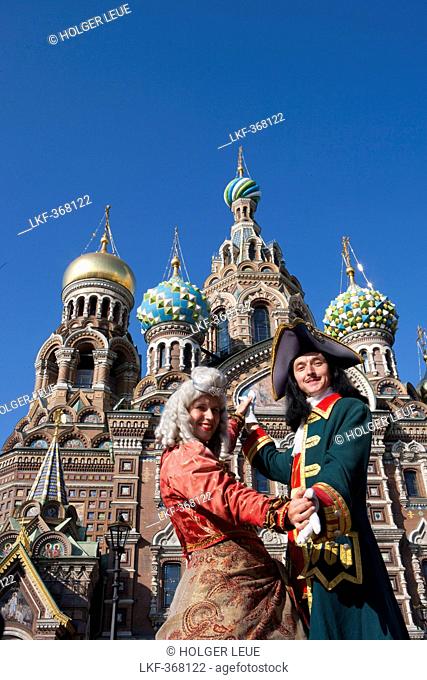 Couple in historic costumes pose as Empress and Tsar in front of Church of the Savior on Spilled Blood, Church of the Resurrection, St