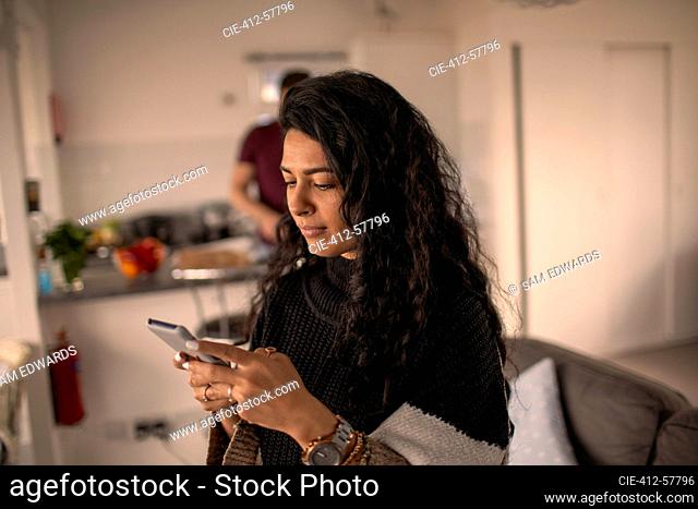 Woman using smart phone at home