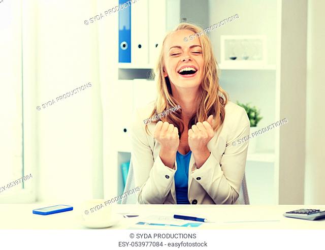 happy businesswoman celebrating success at office