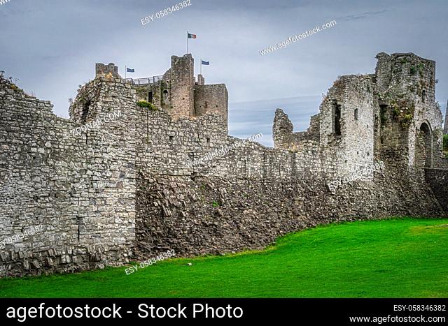 Ruined walls and fortifications of Trim Castle from 12th century with dark moody sky in Trim village, County Meath, Ireland