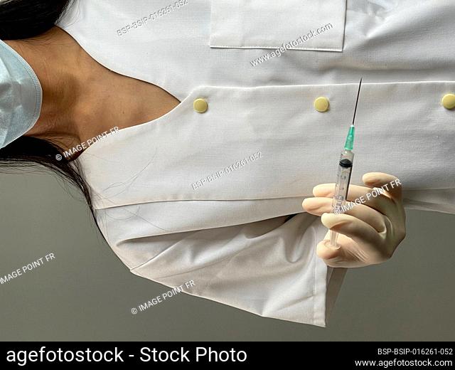 Nurse holding syringe with covid-19 vaccine