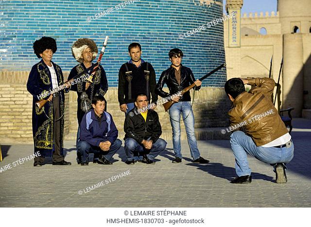 Uzbekistan, Silk Road, Khorezm province, Khiva, Itchan Kala protected city, listed as world heritage by UNESCO, visitors picturing themselves in Emir dress
