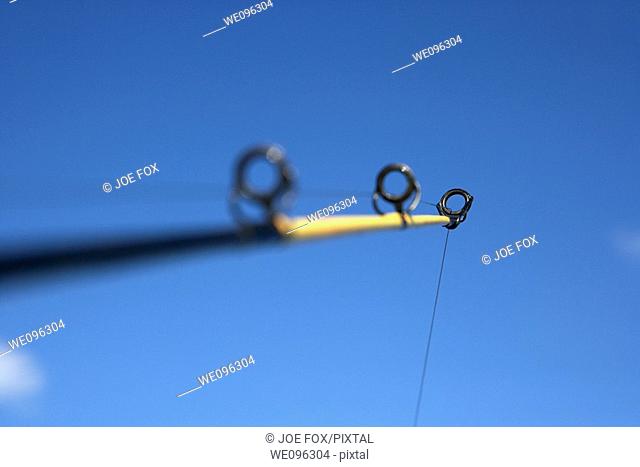 rod and line fishing against blue sky