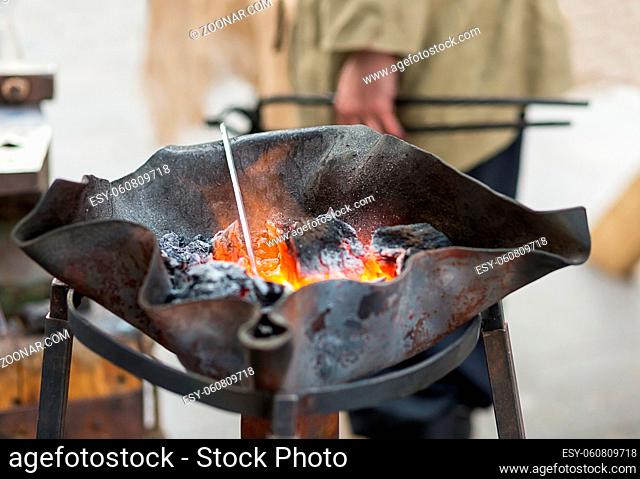 Forge horn with burning coals in a homemade bowl preparation of metal