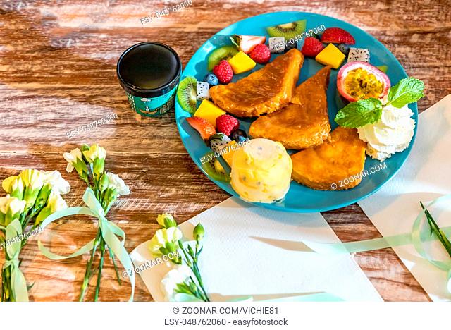 French toast served with exotic tropical fruit with ice cream gelato