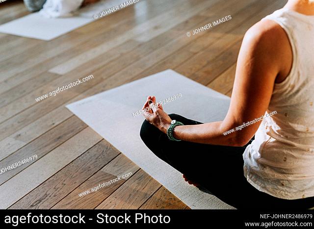 Woman meditating in yoga studio