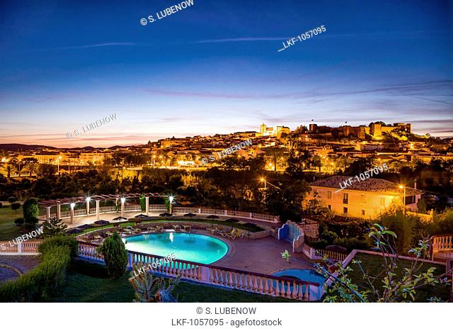 View towards old town, castle and cathedral at dusk, Silves, Algarve, Portugal