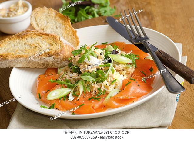 Smoked salmon salad with crab dressing and rocket with toast