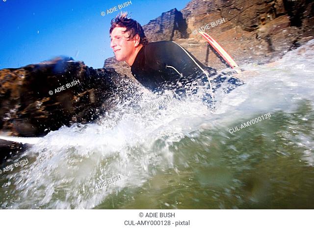 Man on surfboard in splashing water