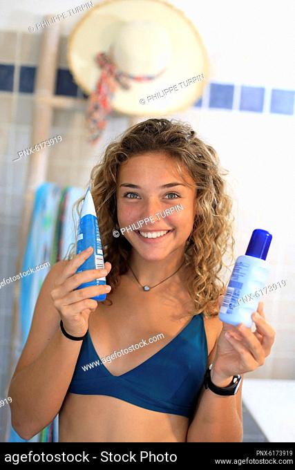 Teenage girl and after sun cream