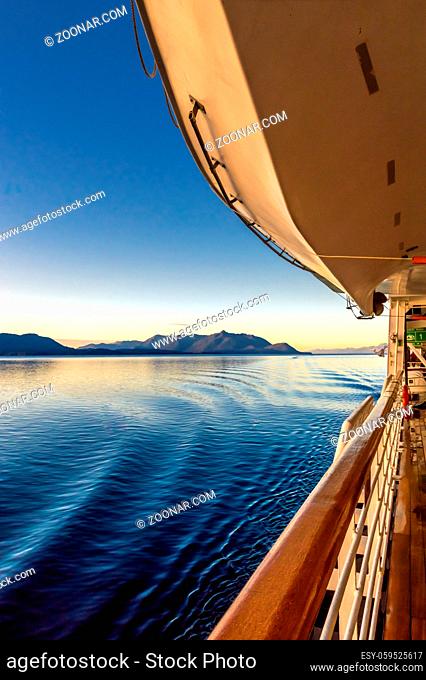 Beautiful crisp and clear morning light at early dawn sunrise passing over gentle water ripples from cruise ship Starboard wake