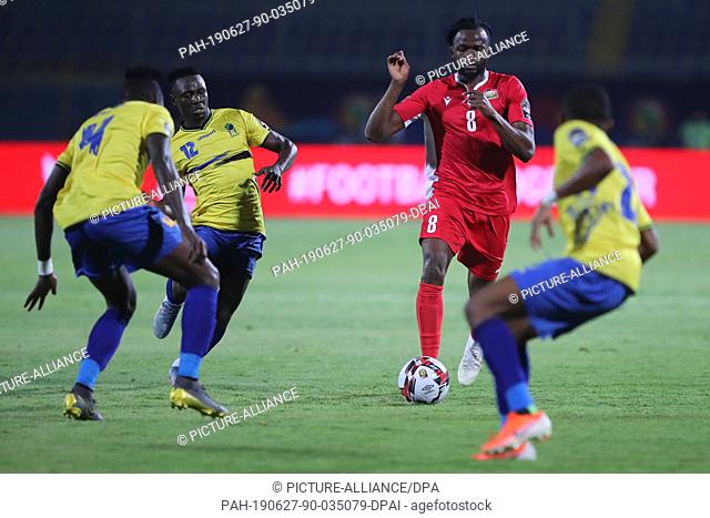 27 June 2019, Egypt, Cairo: Kenya's Johanna Omol (2-R) and Tanzania's Happygod Msuvan (2-L), Erasto Nyoni (L) battle for the ball during the 2019 Africa Cup of...
