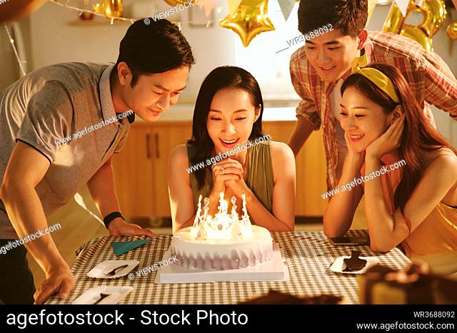 Happy young friends celebrate birthday
