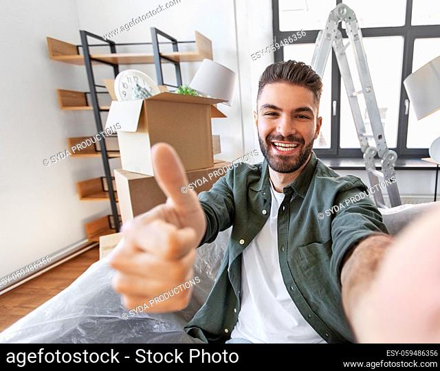 man having video call and moving into new home