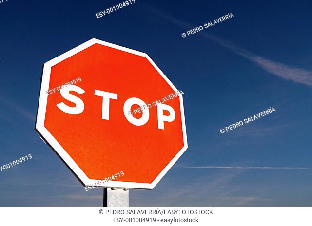 forefront of a stop sign with a blue sky at sunset