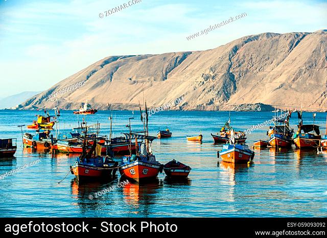 Iquique, Chile - March 17, 2011: Colourful wooden fishing boats in the harbour are resting after the storm