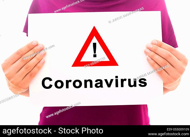 Girl holding white paper sheet with text Corona Virus