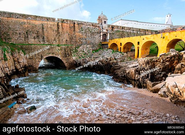 Peniche Fortress with beautiful historic bridge and sea coming from a cave, in Portugal