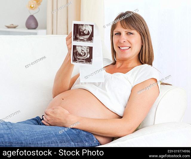 Close up of a pregnant woman holding her baby's ultrasound scan