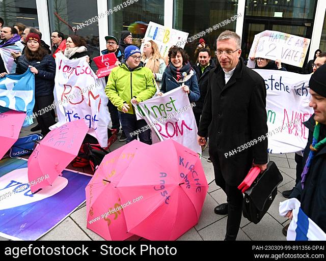 09 March 2023, Hesse, Frankfurt/Main: Michael Gerber, Bishop of Fulda, stands in front of demonstrators protesting for equal rights for women in the church as...