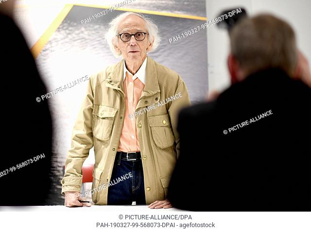 27 March 2019, Berlin: Hiding artist Christo signs his books ""Hidden Reichstag"", ""The Floating Piers"" and ""Barrels and The Mastaba"" in the flagship store...