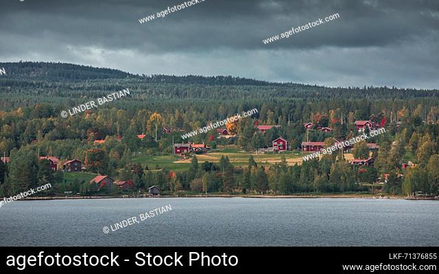 Red Swedish houses on the lakeshore of Lake Siljan in Dalarna, Sweden