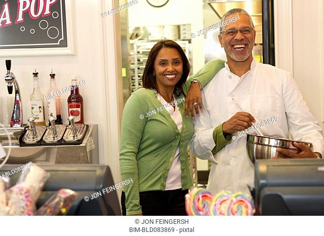 Small business owners standing in bakery shop