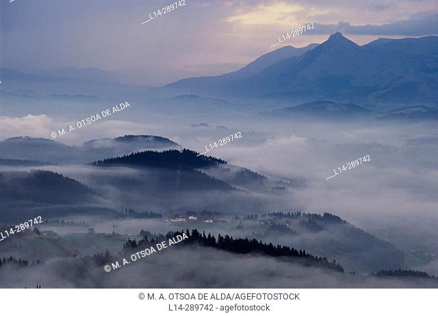 Valle de Goierri with mist and Sierra de Aralar in background. Gipuzkoa. Basque Country. Spain