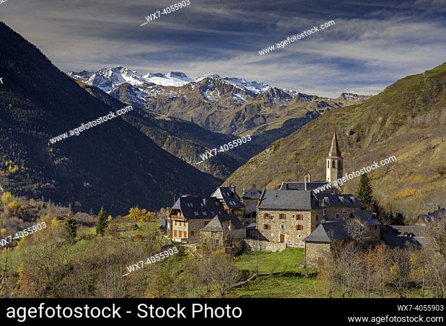 Aran Valley in autumn. In the foreground, the village of Unha, and in the background, Maladeta range with Aneto peak, the highest of Pyrenees (Catalonia, Spain)