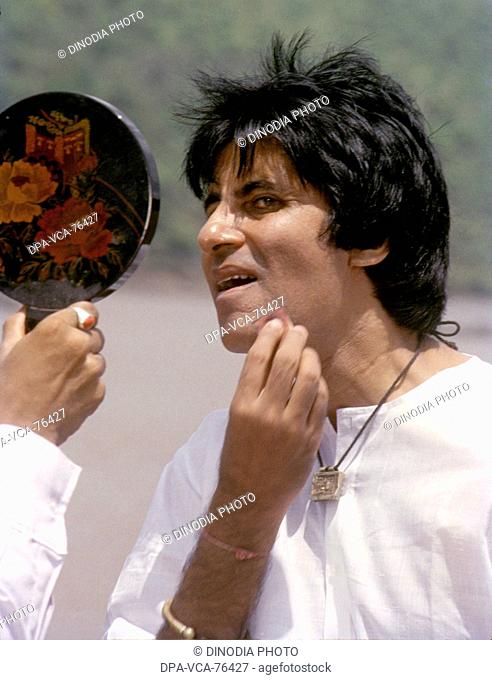 South Asian , Indian Bollywood Film Star Actor Amitabh Bachchan applying makeup on film set in India NO MODEL RELEASED