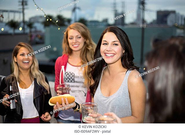 Female friends enjoying food at rooftop barbecue