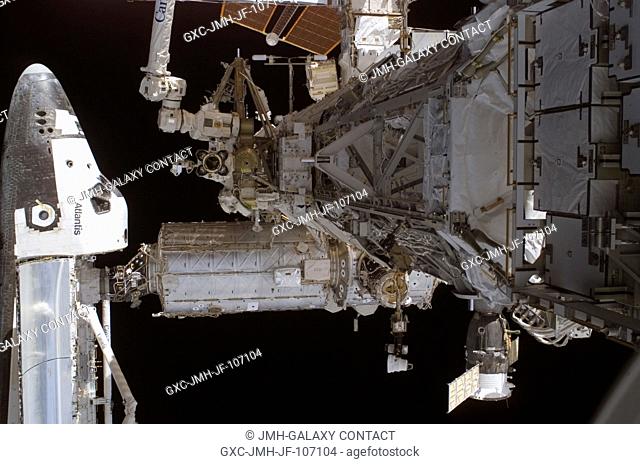 Although no astronauts are visible in this picture, action was brisk outside the space shuttlespace station tandem when this digital still image was recorded on...