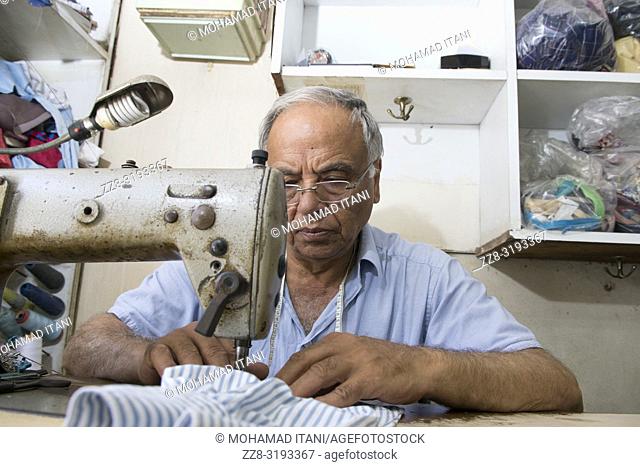 Tailor working with a sewing machine