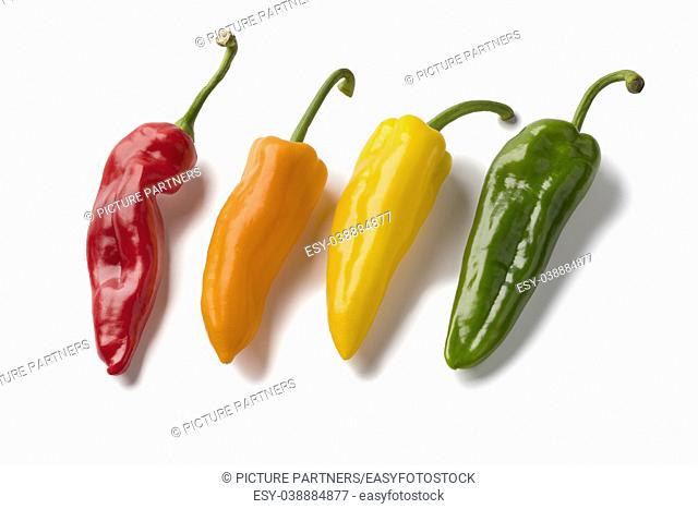 Fresh variety of red, yellow, orange and green sweet pointed peppers isolated on white background